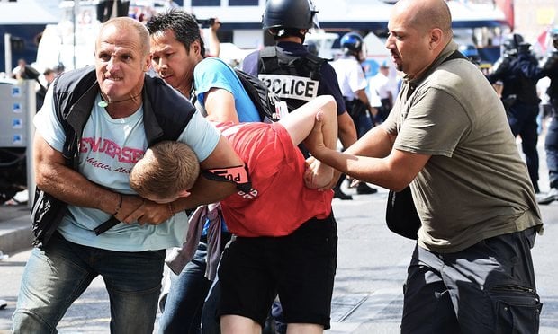 an england fan is detained by police following clashes between england fans and police in marseille photo afp