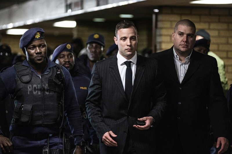 oscar pistorius surrounded by policemen as he arrives at pretoria high court to attend a sentencing hearing photo afp