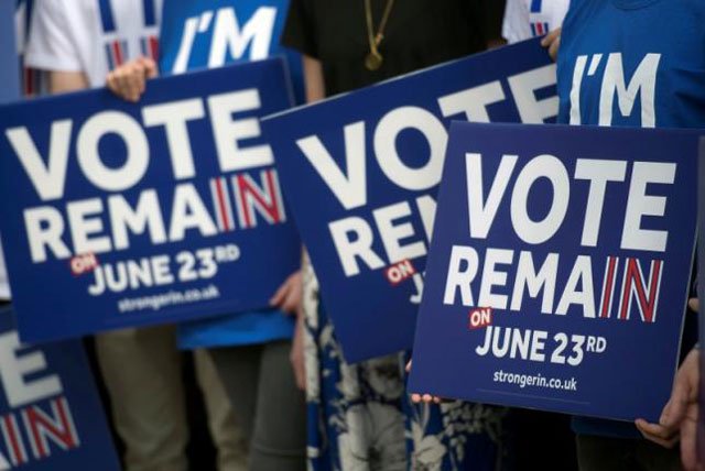 campaigners hold placards as british prime minister david cameron delivers a speech at a 039 stronger in 039 campaign event in witney oxfordshire britain 14 may 2016 photo reuters