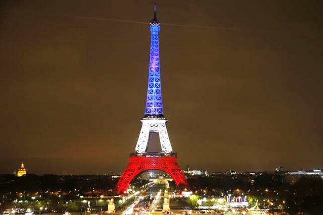 the eiffel tower is lit with the blue white and red colours of the french flag in paris france november 16 2015 to pay tribute to the victims of a series of deadly attacks on friday in the french capital photo reuters