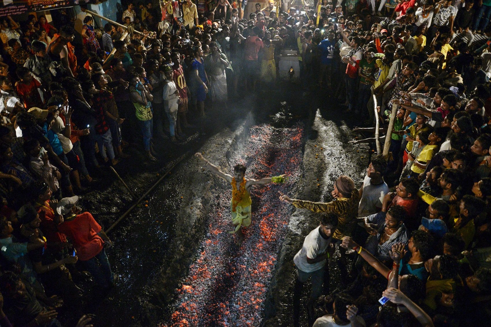 an indian hindu devotee runs on burning coals at the maa maariamma mela event in jalandhar on june 12 2016 devotees run on burning coals after fasting for seven days to prove their religious devotion photo afp