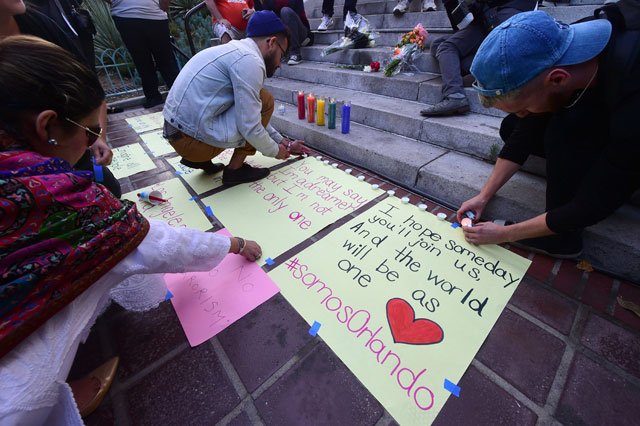 candles are light during a rally and vigil for the shootings in orlando at los angeles city hall on june 13 2016 in los angeles california organized by the los angeles lgbt center photo afp