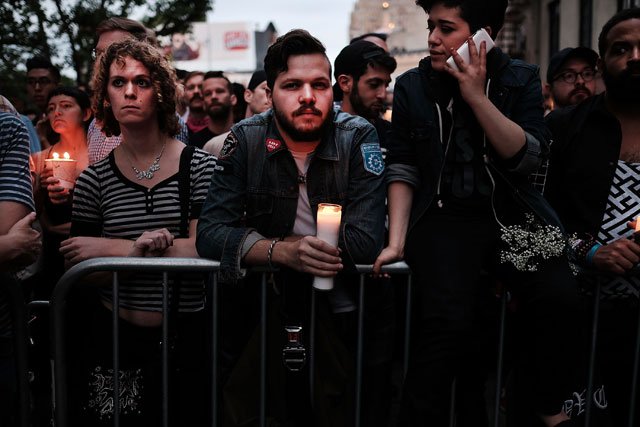 hundreds of people listen to speakers at a memorial gathering for those killed in orlando in front of the iconic new york city gay and lesbian bar the stonewall inn on june 13 2016 in new york city photo afp