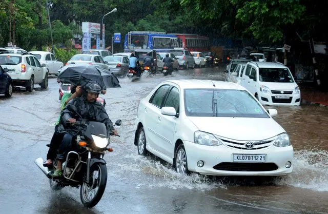 this file photograph taken on june 8 2016 shows indian commuters as they make their way along a waterlogged road during heavy monsoon rains in kochi photo afp file this file photograph taken on june 8 2016 shows indian commuters as they make their way along a waterlogged road during heavy monsoon rains in kochi photo afp file