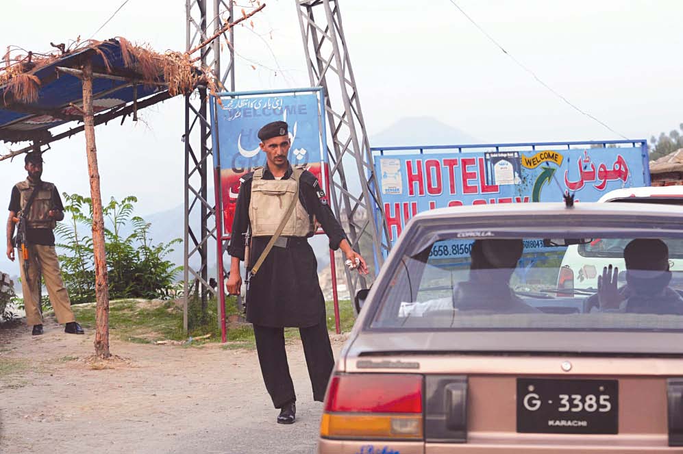 policemen check vehicles at checkpoints in swat valley photo afp