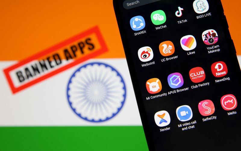 smartphone with chinese applications is seen in front of a displayed indian flag in this illustration picture taken july 2 2020 photo reuters