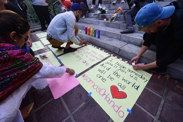 candles are lit during a rally and vigil for the shootings in orlando at los angeles city hall on june 13 2016 in los angeles california organized by the los angeles lgbt center photo afp