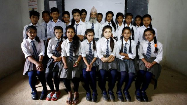 nepalese grandfather durga kami brushes his bushy white beard puts on his school uniform and with the aid of his walking stick trudges for over an hour to class for another day of learning photo reuters