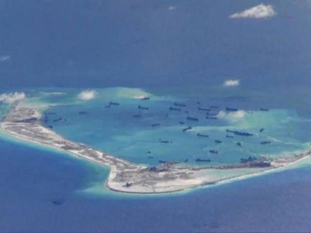 chinese dredging vessels are purportedly seen in the waters around mischief reef in the disputed spratly islands in the south china sea photo reuters