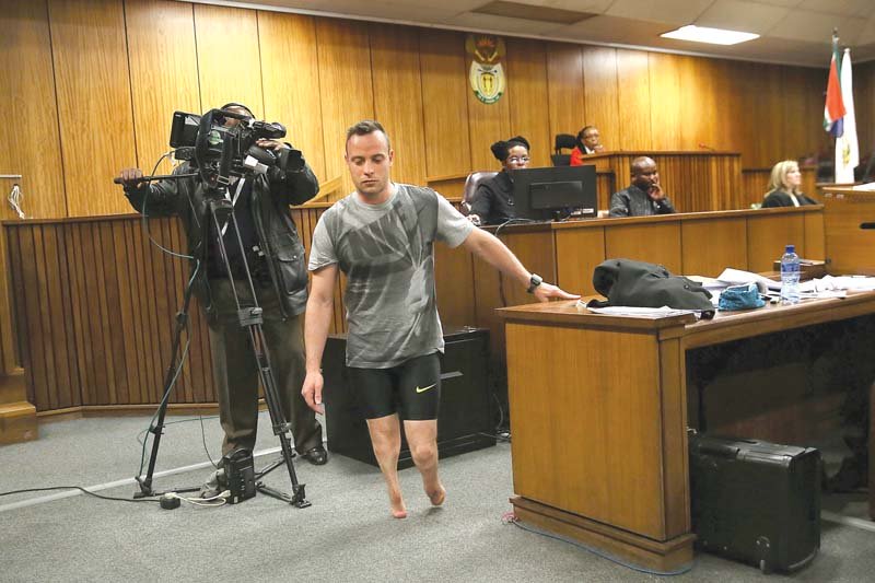 paralympic athlete oscar pistorius walks in the courtroom without his prosthetic legs during his resentencing hearing photo afp