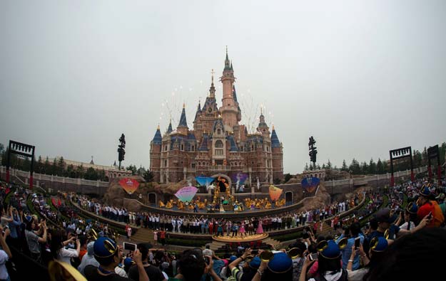 fireworks explode over the enchanted storybook castle during the opening ceremony of the shanghai disney resort in shanghai on june 16 2016 photo afp