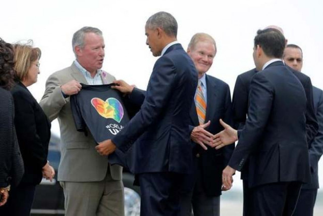 us president barack obama receives a t shirt from mayor of orlando buddy dyer c as he arrives in orlando to meet with families of victims of the pulse nightclub shooting in florida us june 16 2016 photo reuters us president barack obama receives a t shirt from mayor of orlando buddy dyer c as he arrives in orlando to meet with families of victims of the pulse nightclub shooting in florida us june 16 2016 photo reuters