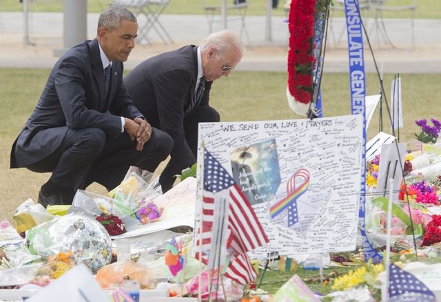 us president barack obama and vice president joe biden place flowers for the victims of the mass shooting at a gay nightclub at a memorial in orlando florida on june 16 2016 photo afp