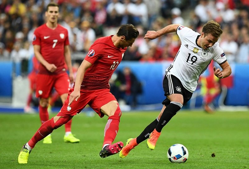 grzegorz krychowiak vies for the ball against mario goetze at the stade de france stadium in saint denis near paris on june 16 2016 photo afp