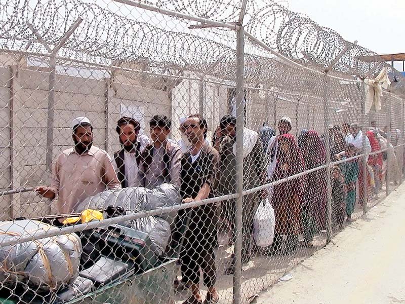 people from afghanistan enter pakistan through the torkham border which reopened on saturday photo inp