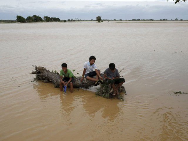footage aired by local broadcasters shows villagers sitting on their roofs to escape the rising water photo reuters