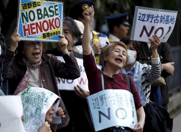 people protesting the planned relocation of the us military base to okinawa 039 s henoko coast shout slogans at a rally in front of prime minister shinzo abe 039 s official residence as a meeting between okinawa governor takeshi onaga and abe takes place in tokyo in this april 17 2015 file photo photo reuters