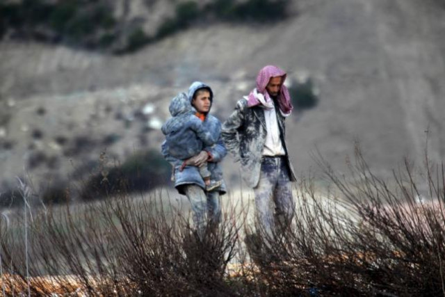 internally displaced people covered with mud waiting to get permission to cross into turkey near the syrian turkish border syria february 7 2016 photo reuters internally displaced people covered with mud waiting to get permission to cross into turkey near the syrian turkish border syria february 7 2016 photo reuters