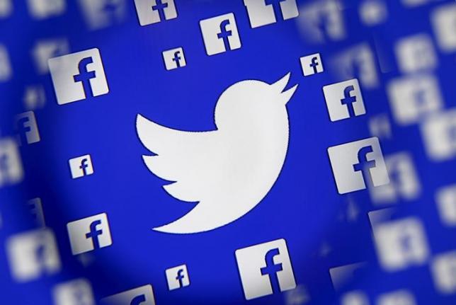 logo of the twitter and facebook are seen through magnifier on display in this illustration taken in sarajevo bosnia and herzegovina december 16 2015 photo reuters