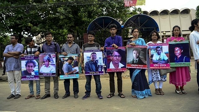bangladeshi activists hold the photos of activists writers and bloggers photo afp