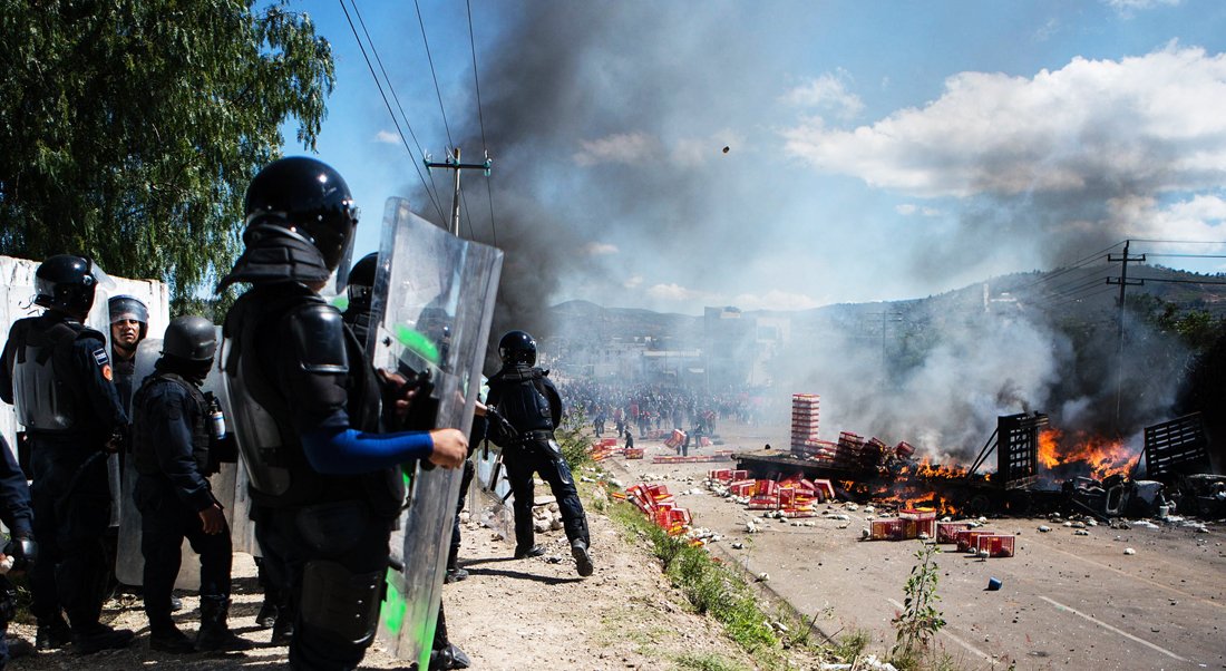 at least three people were killed and dozens injured when police clashed with thousands of teachers blocking roads in a protest in southern mexico on sunday leaving some officers with bullet wounds afp photo