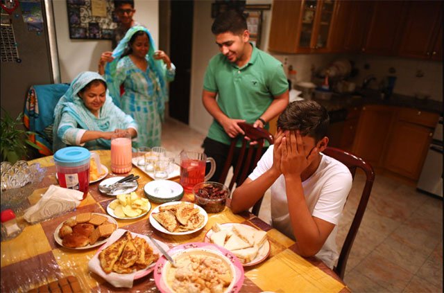 praying before the family sits down to break their ramazan fast photo new york times