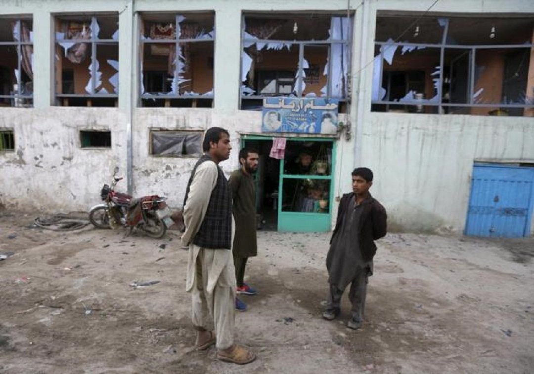 afghan shopkeepers look at the broken windows of their shop after a suicide car bomb attack in kabul photo reuters