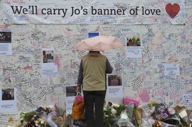 a woman views tributes in memory of murdered labour party mp jo cox who was shot dead in birstall at parliament square in london britain june 20 2016 photo reuters a woman views tributes in memory of murdered labour party mp jo cox who was shot dead in birstall at parliament square in london britain june 20 2016 photo reuters
