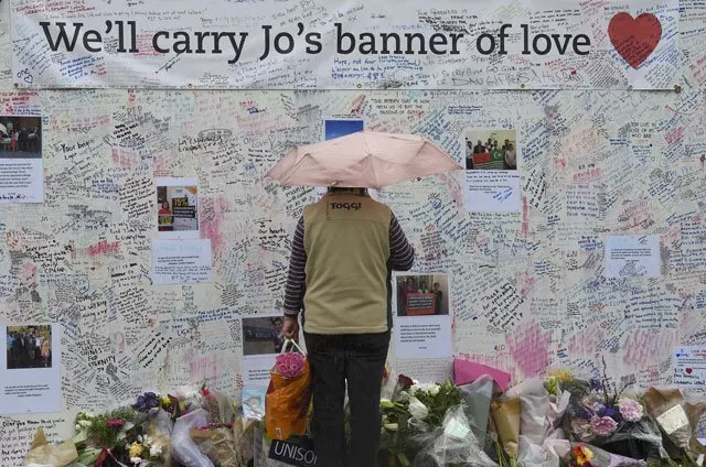 a woman views tributes in memory of murdered labour party mp jo cox who was shot dead in birstall at parliament square in london britain june 20 2016 photo reuters a woman views tributes in memory of murdered labour party mp jo cox who was shot dead in birstall at parliament square in london britain june 20 2016 photo reuters