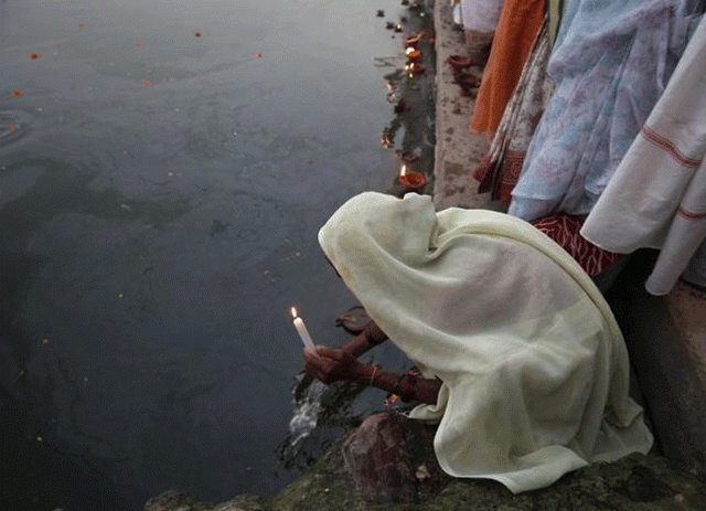 a widow who was abandoned by her family holds an earthen oil lamp while offering prayers on the banks of the river yamuna as part of diwali celebrations organised by non governmental organisation sulabh international in vrindavan in uttar pradesh october 21 2014 photo reuters a widow who was abandoned by her family holds an earthen oil lamp while offering prayers on the banks of the river yamuna as part of diwali celebrations organised by non governmental organisation sulabh international in vrindavan in uttar pradesh october 21 2014 photo reuters