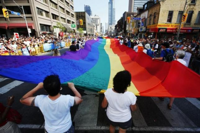 revelers hold a giant pride flag during the quot worldpride quot gay pride parade in toronto june 29 2014 photo reuters revelers hold a giant pride flag during the quot worldpride quot gay pride parade in toronto june 29 2014 photo reuters