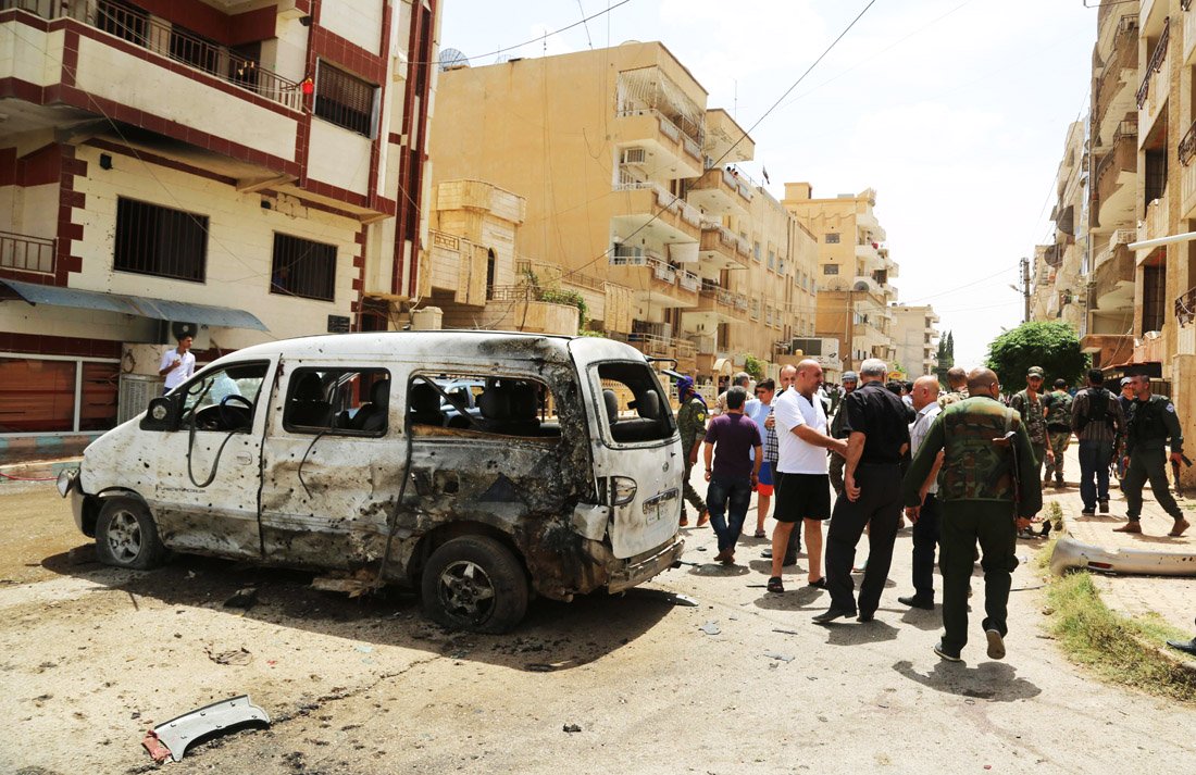 people and security forces belonging to the sotoro a christian militia based in syria 039 s northeast gather at the site of a suicide bomb attack carried out on june 19 2016 in the divided syrian city of qamishli during an event commemorating the massacre of christians more than a century ago photo afp