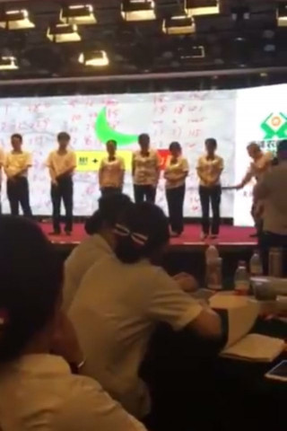 the video showed eight employees four men and four women lined up on a stage and being asked by a man why they came last in a competition screen grab the video showed eight employees four men and four women lined up on a stage and being asked by a man why they came last in a competition screen grab