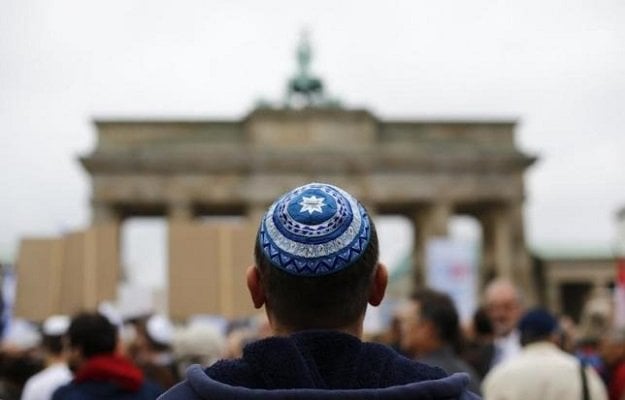 a man wearing a kippah waits for the start of an anti semitism demonstration photo reuters