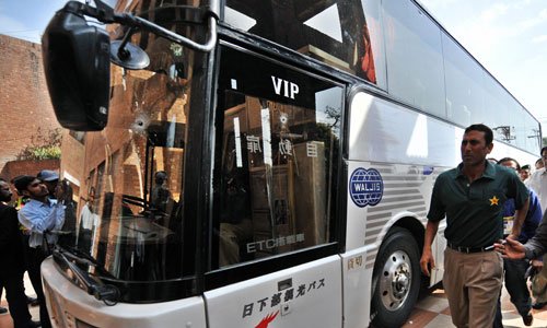 younis khan walks past the bullet ridden team bus in lahore on march 3 2009 photo afp