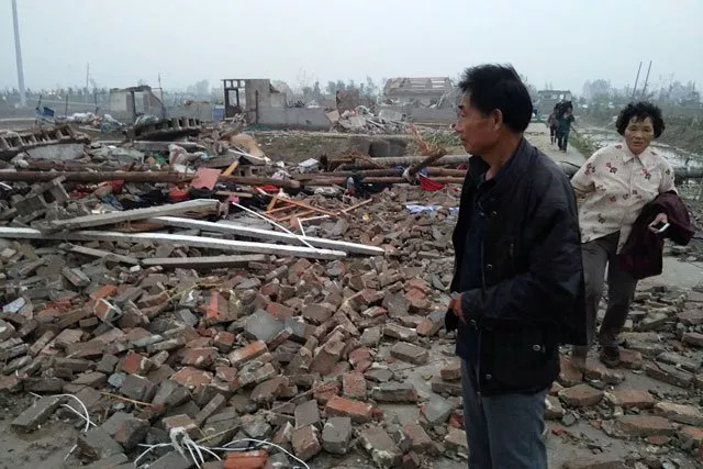 a man stands on debris of houses after a tornado hit funing county yancheng jiangsu province june 23 2016 photo reuters a man stands on debris of houses after a tornado hit funing county yancheng jiangsu province june 23 2016 photo reuters
