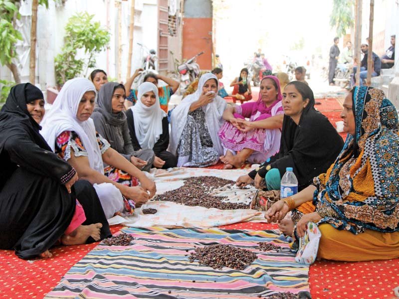 mourners sit under a canopy as they recite prayers before the funeral of qawwal amjad sabri the streets of liaquatabad were filled with family members neighbours and fans trying to catch a last glimpse of the qawwali maestro photo aysha saleem express