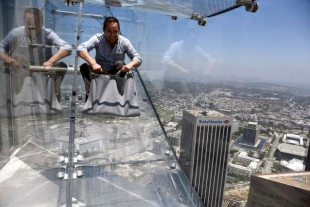 a member of the media rides the skyslide from the 70th to 69th floor of the us bank tower which is attached to the oue skyspace la observation deck in downtown los angeles california us june 23 2016 photo reuters a member of the media rides the skyslide from the 70th to 69th floor of the us bank tower which is attached to the oue skyspace la observation deck in downtown los angeles california us june 23 2016 photo reuters
