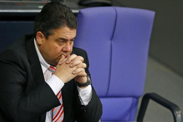 german economy minister and vice chancellor sigmar gabriel sits beside the empty chair of german chancellor angela merkel not pictured as she addresses the german lower house of parliament bundestag in berlin december 18 2013 photo reuters