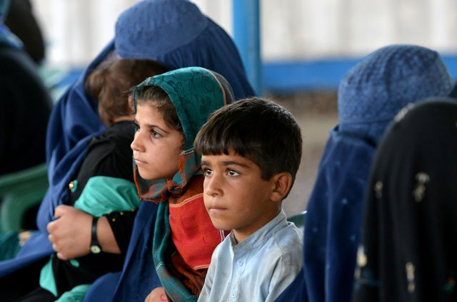 afghan refugees wait at the unhcr registration centre in peshawar on june 23 2016 photo afp