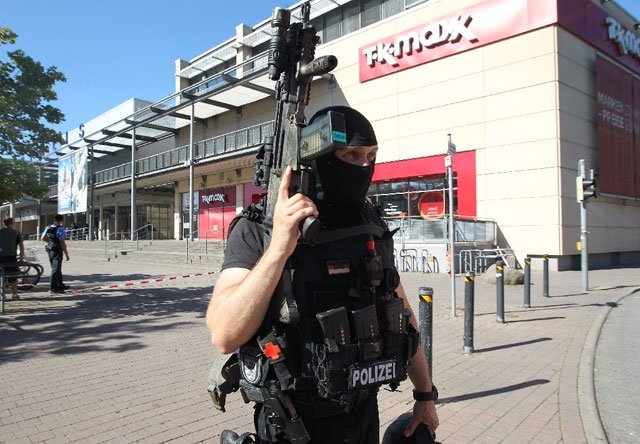 a policeman stands near a cinema where an armed man barricaded himself in viernheim southern germany on june 23 2016 photo afp