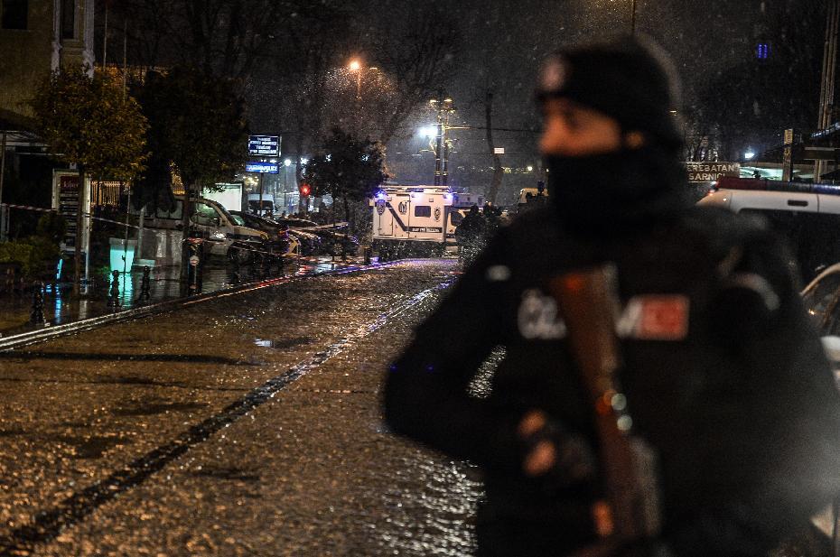 a turkish police officer stands guard along a street leading to where a female suicide bomber was killed on january 6 2015 when she blew herself up in an attack on the police station in the main tourist district of istanbul photo afp