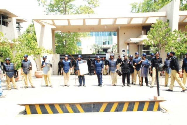 policemen guard the club during a protest by its employees photo abid nawaz express policemen guard the club during a protest by its employees photo abid nawaz express