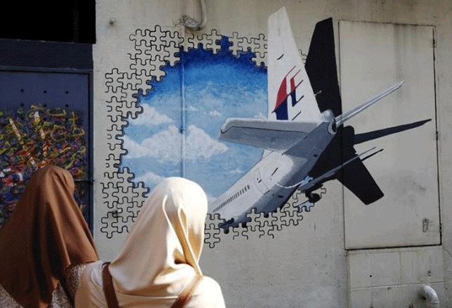 women look at a mural of missing malaysia airlines flight mh370 two years after it disappeared in kuala lumpur malaysia march 7 2016 photo reuters