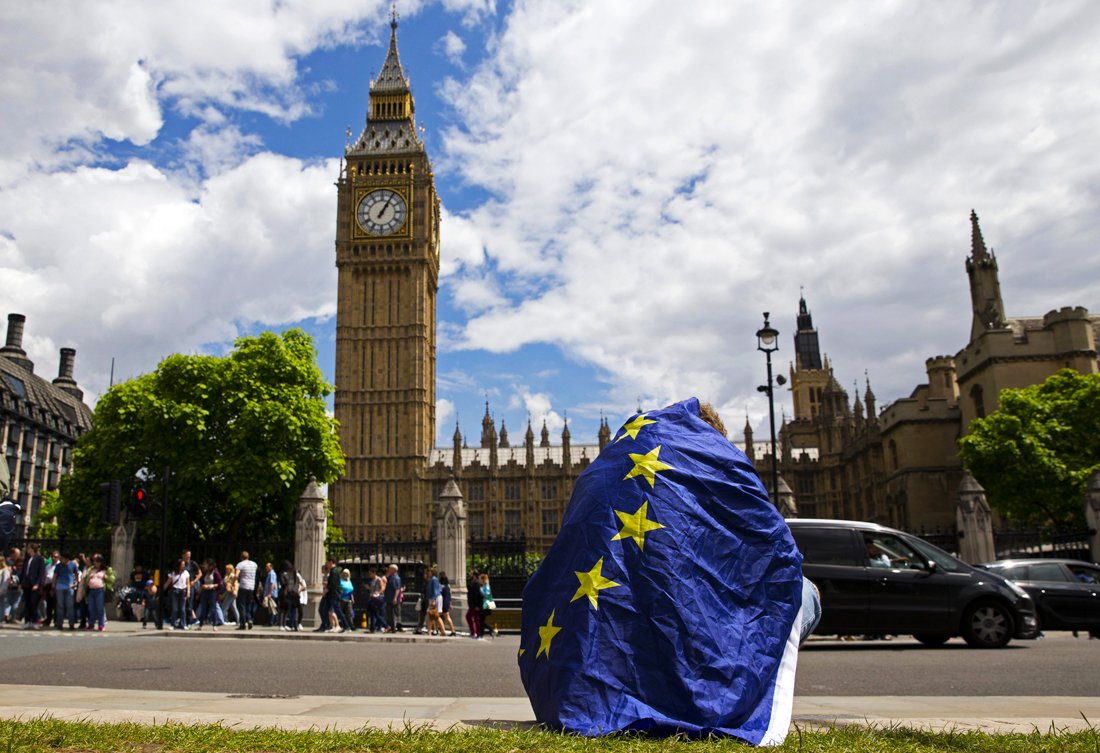 a demonstrator draped in an eu flag sits on floor during a protest against the outcome of the uk 039 s june 23 referendum on the european union eu in central london on june 25 2016 photo afp