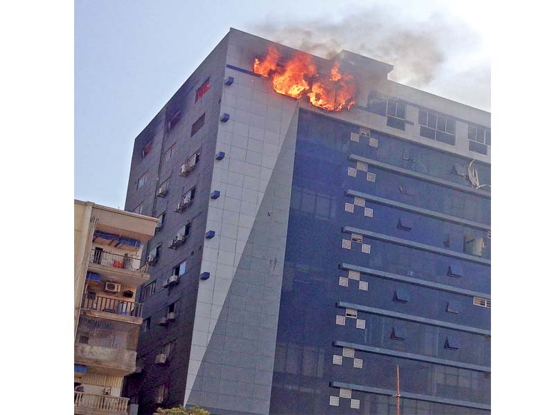 the back of the third floor of the glass building clifton diamond caught fire on saturday night and was controlled at around 9am a large fire once again broke out on sunday at around 2pm on the top floor of the building photo ayesha mir express