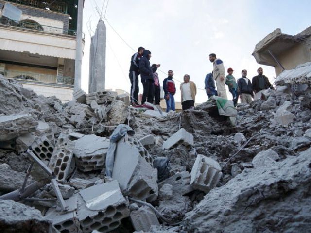 residents inspect a damaged site from what activists said were airstrikes carried out by the russian air force in nawa city deraa syria on november 21 2015 photo reuters