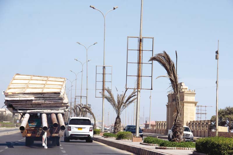 on sc orders billboards erected on public properties are being removed all over karachi including sea view road above which falls under cbc photo ayesha mir express