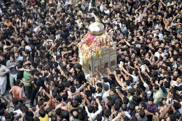 mourners pay respect to a replica of hazrat ali 039 s mausoleum photo app