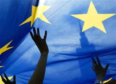 people wave a european union flag in front of the palace of culture during a eu parade in warsaw in a file photo photo reuters reuters katarina stoltz